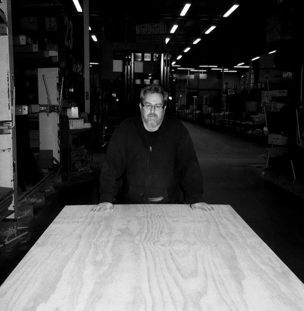 plywood on a cart, John Heisz behind John Heisz pushing plywood on a cart
