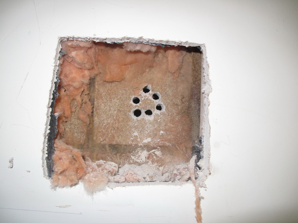 Holes drilled in a circle to make a bigger hole through a block wall