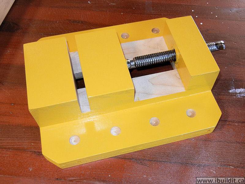yellow paint on a wooden drill press vise